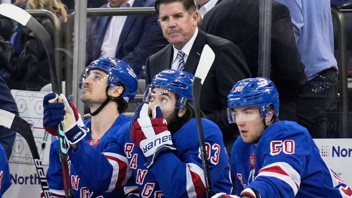FILE - New York Rangers coach Peter Laviolette, top, watches during the first period of an NHL hockey game against the Tampa Bay Lightning in New York, April 17, 2025.