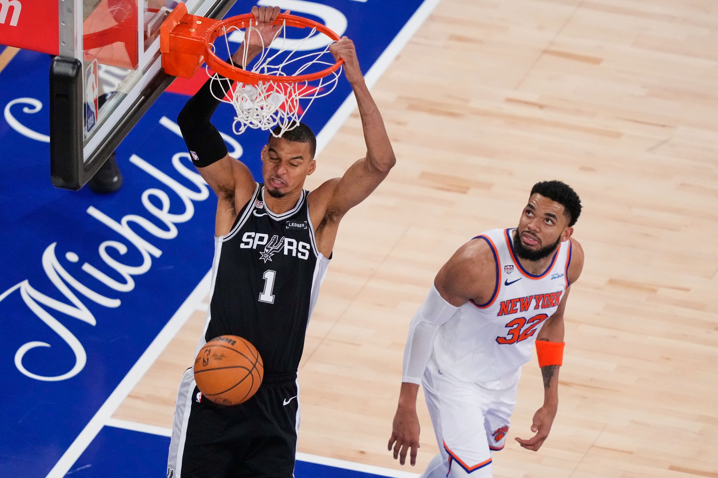 San Antonio Spurs forward Victor Wembanyama (1) dunks as New York Knicks center Karl-Anthony Towns (32) looks on during the second half of Game 3 of the NBA Finals basketball series, Monday, June 8, 2026, in New York.