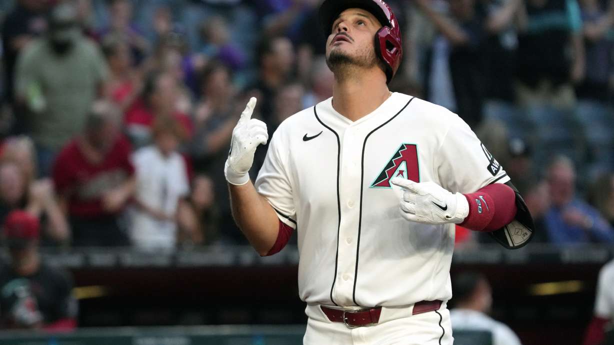 Arizona Diamondbacks' Nolan Arenado celebrates after hitting a grand slam against the San Francisco Giants in the first inning of a baseball game, Monday, May 18, 2026, in Phoenix.