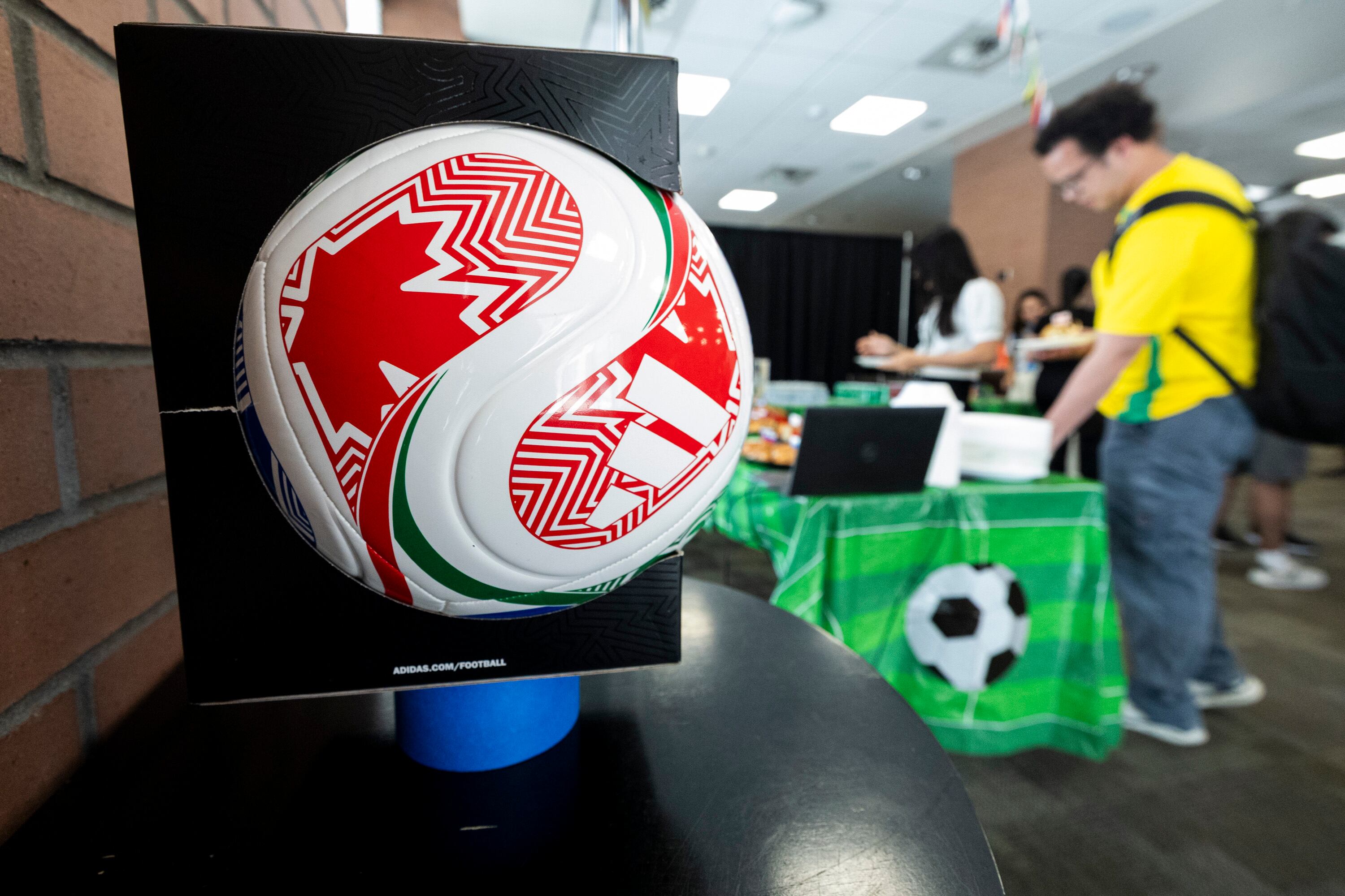 Attendees get food during a FIFA World Cup kick-off party held at Ensign College in Salt Lake City on Thursday. Some of the students at the school are also involved in collecting Panini World Cup stickers.