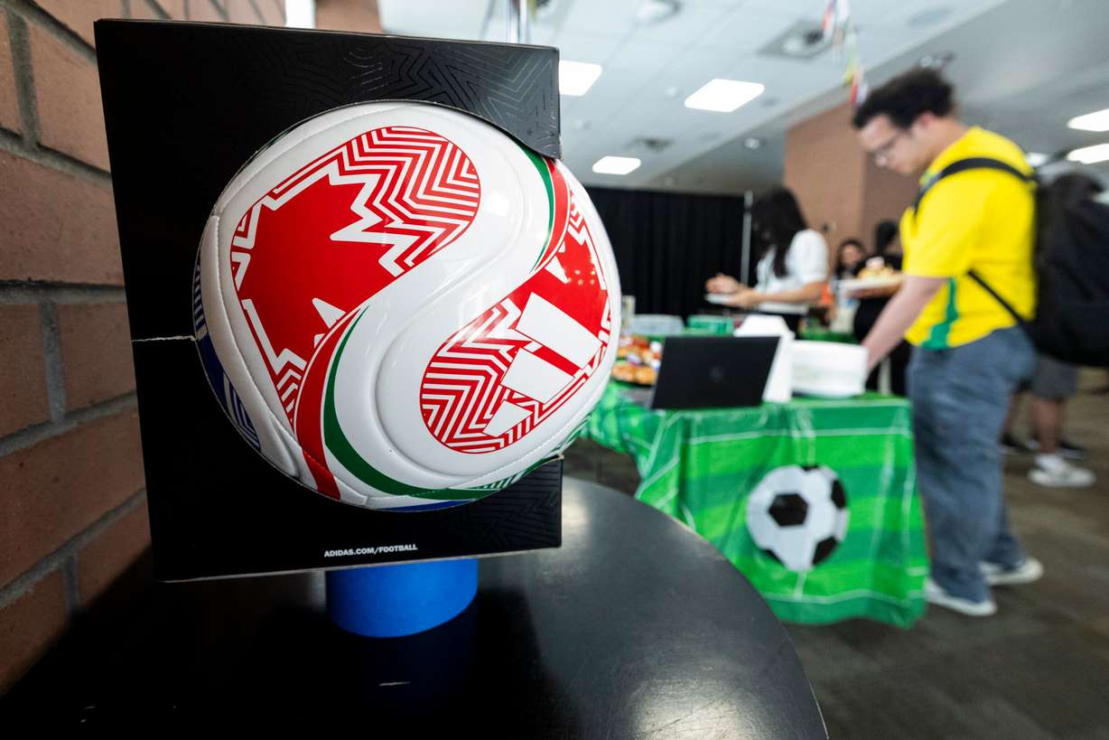 Attendees get food during a FIFA World Cup kick-off party held at Ensign College in Salt Lake City on Thursday. Some of the students at the school are also involved in collecting Panini World Cup stickers.