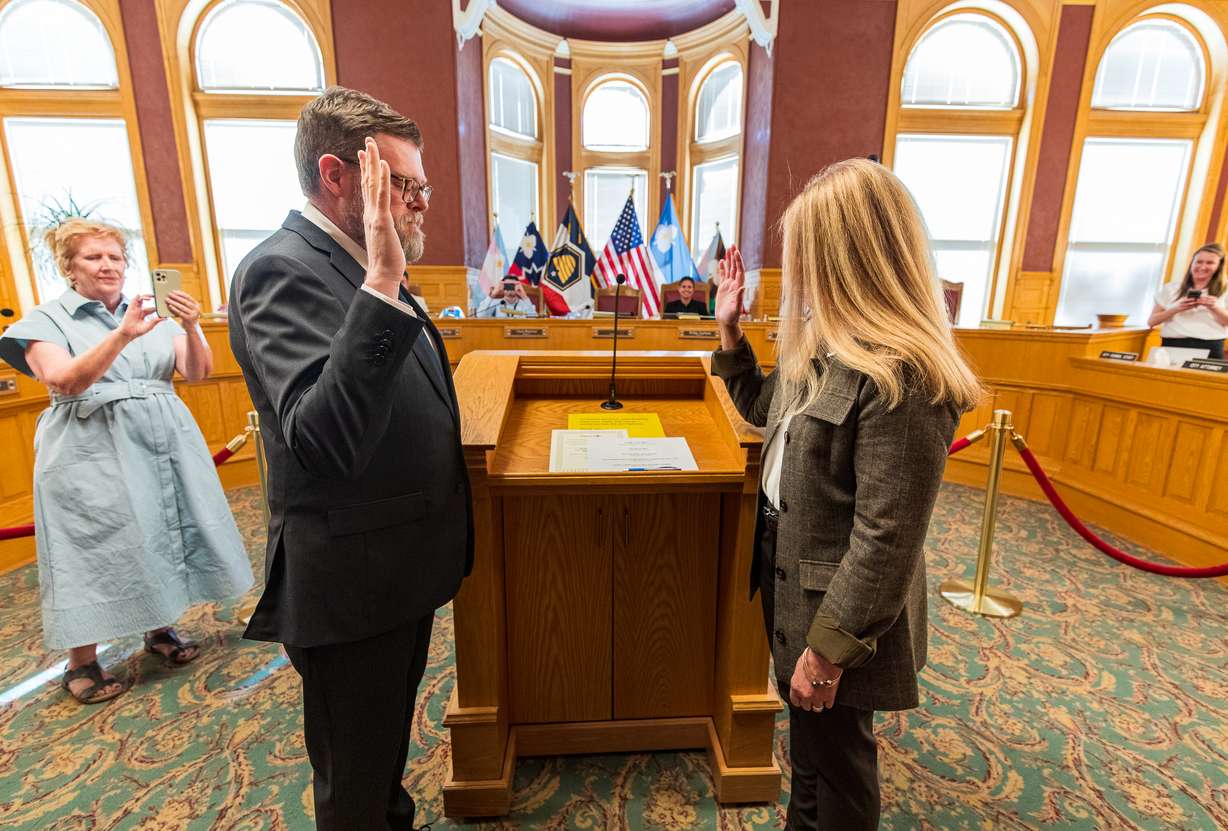 Salt Lake City recorder Keith Reynolds, left, swears in Jennifer Napier-Pearce after a Salt Lake City Council special election Tuesday evening. Napier-Pearce won the seat through a coin flip.