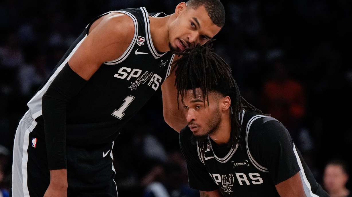 San Antonio Spurs forward Victor Wembanyama (1) talks with guard Stephon Castle during second half of Game 3 of the NBA Finals basketball series against the New York Knicks, Monday, June 8, 2026, in New York.