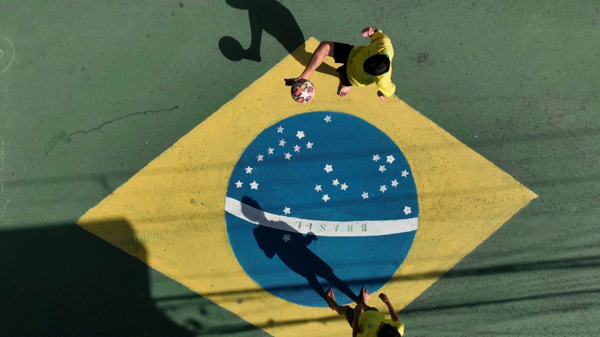 Boys play soccer on a decorated street in Osasco, in the greater Sao Paulo area, Brazil, Friday, June 5, 2026, ahead of the World Cup soccer tournament.