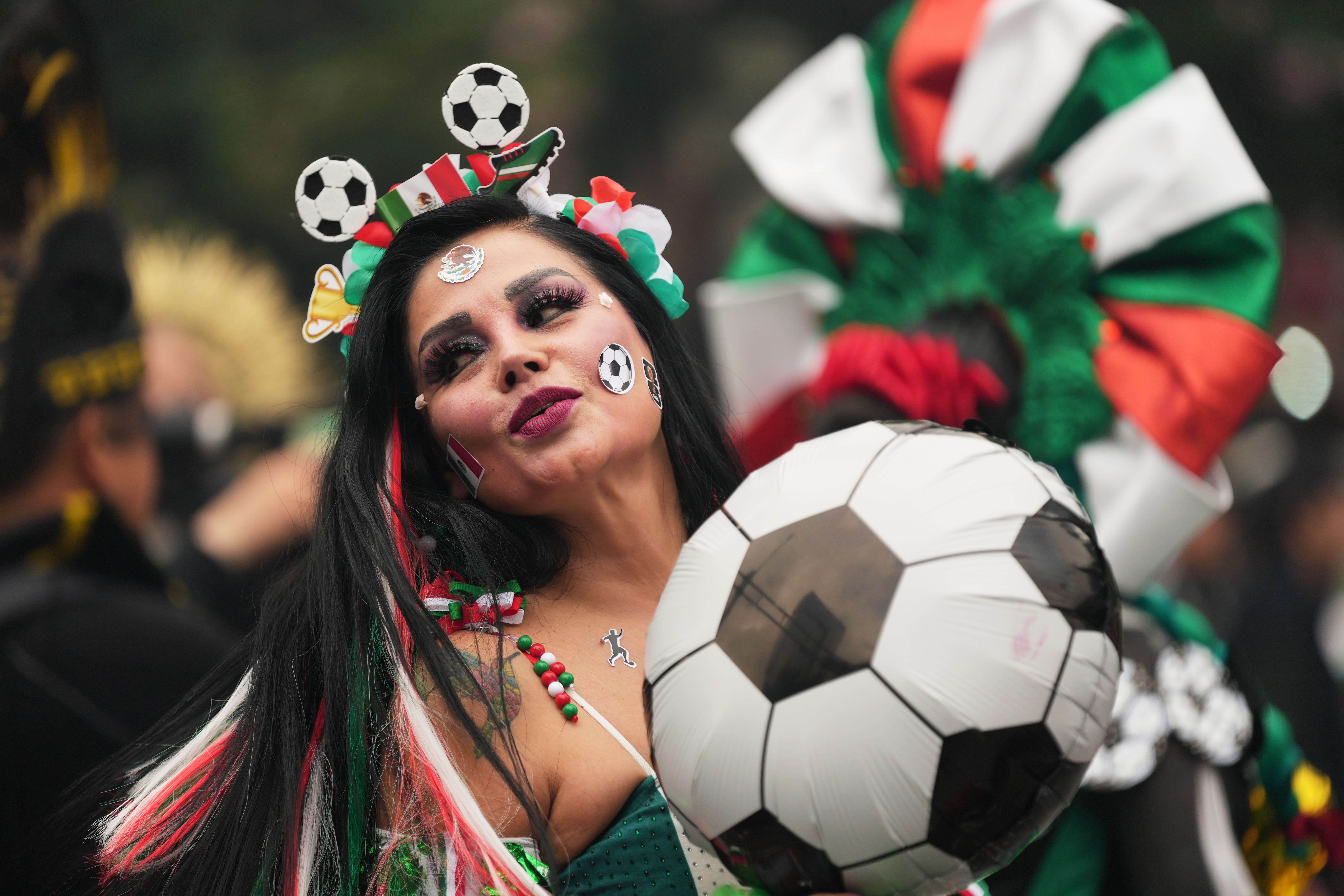 A dancer performs along Reforma Avenue in Mexico City, Saturday, ahead of the FIFA World Cup. After years of preparation, a supersized World Cup has finally arrived.
