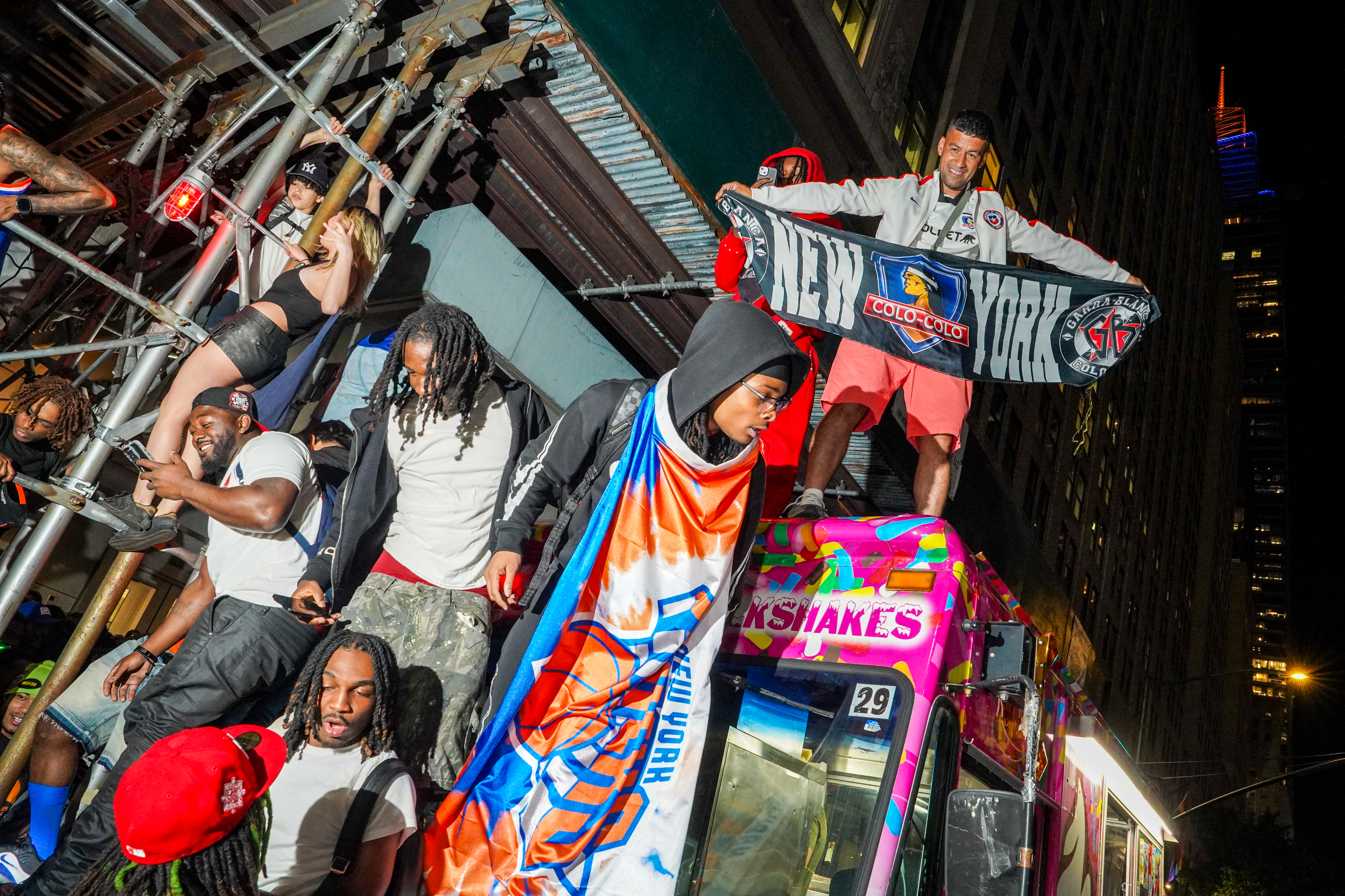 New York Knicks fans celebrate on the street outside of a watch party in Bryant Park for Game 3 of the NBA Finals basketball series between the Knicks and the San Antonio Spurs, Monday, June 8, 2026, in New York.