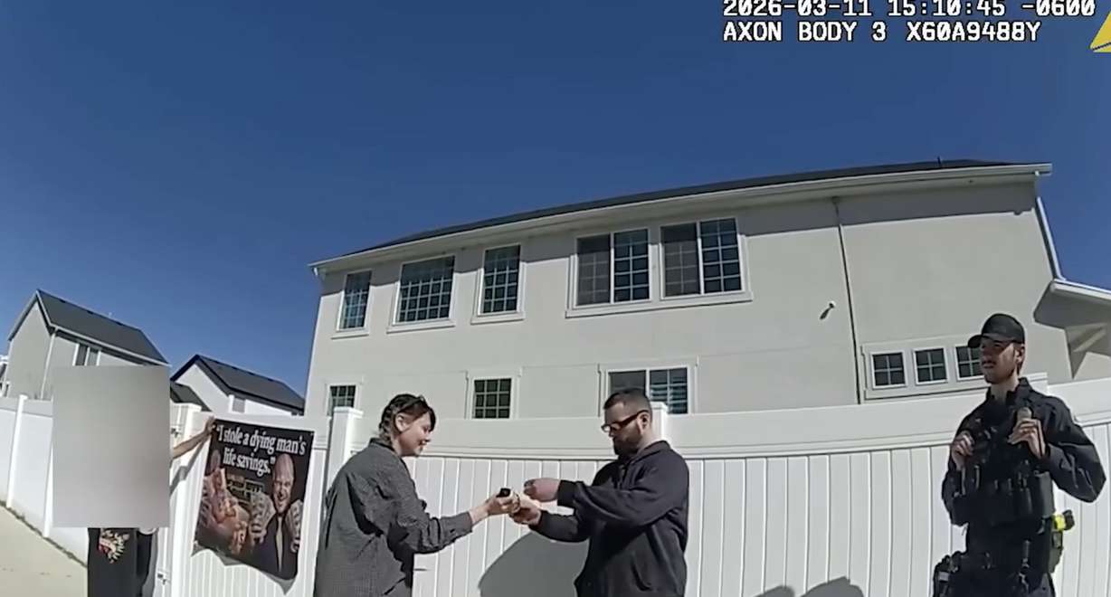 Body camera footage shows people associated with Benjamin Schneider hanging up a sign advertising a GoFundMe.