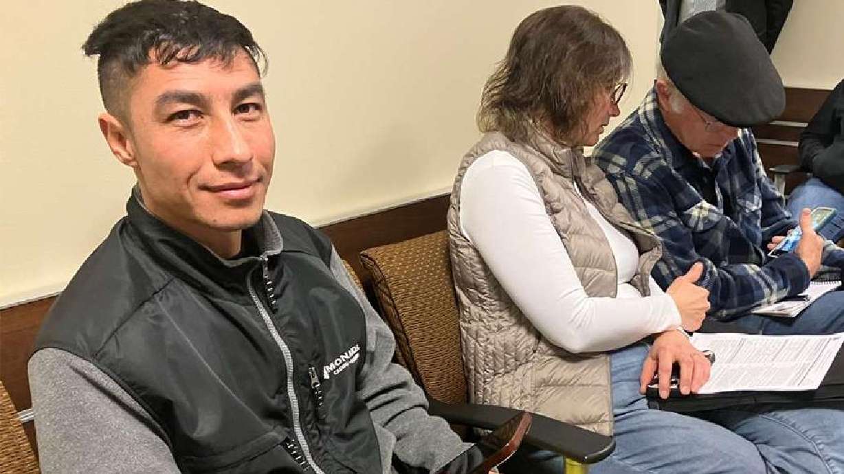 Zafar Zulfaqar checks his phone in the waiting room for his appointment with U.S. Immigration and Customs Enforcement on Feb. 12.