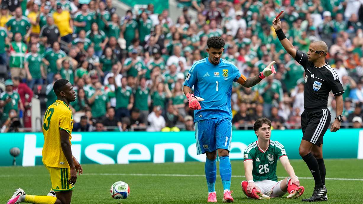 Referee Wilton Sampaio a red card to South Africa's Sphephelo Sithole, left, during the World Cup Group A soccer match between Mexico and South Africa in Mexico City, Thursday, June 11, 2026.