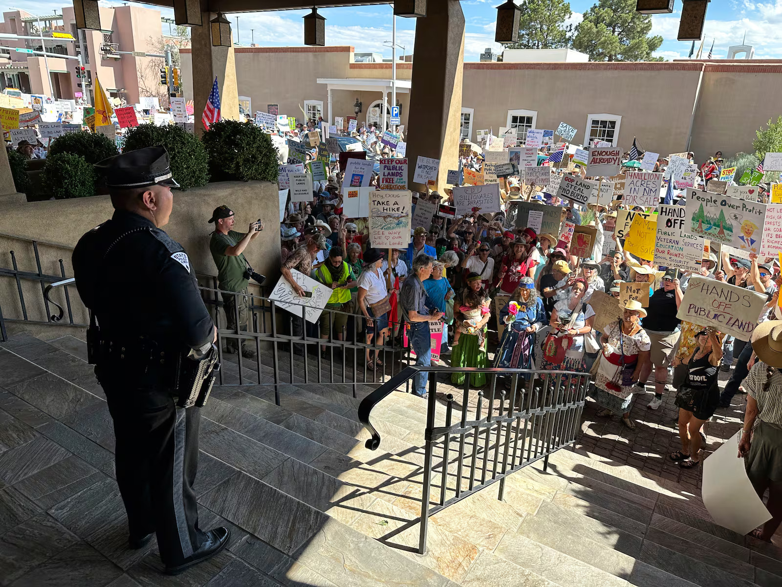 Hundreds of people protest efforts to privatize federal public land outside a meeting of governors from Western states and top Trump administration officials in Santa Fe, N.M., June 23, 2025. A Senate bill to repeal the "Roadless Rule" advanced out of committee on Wednesday.