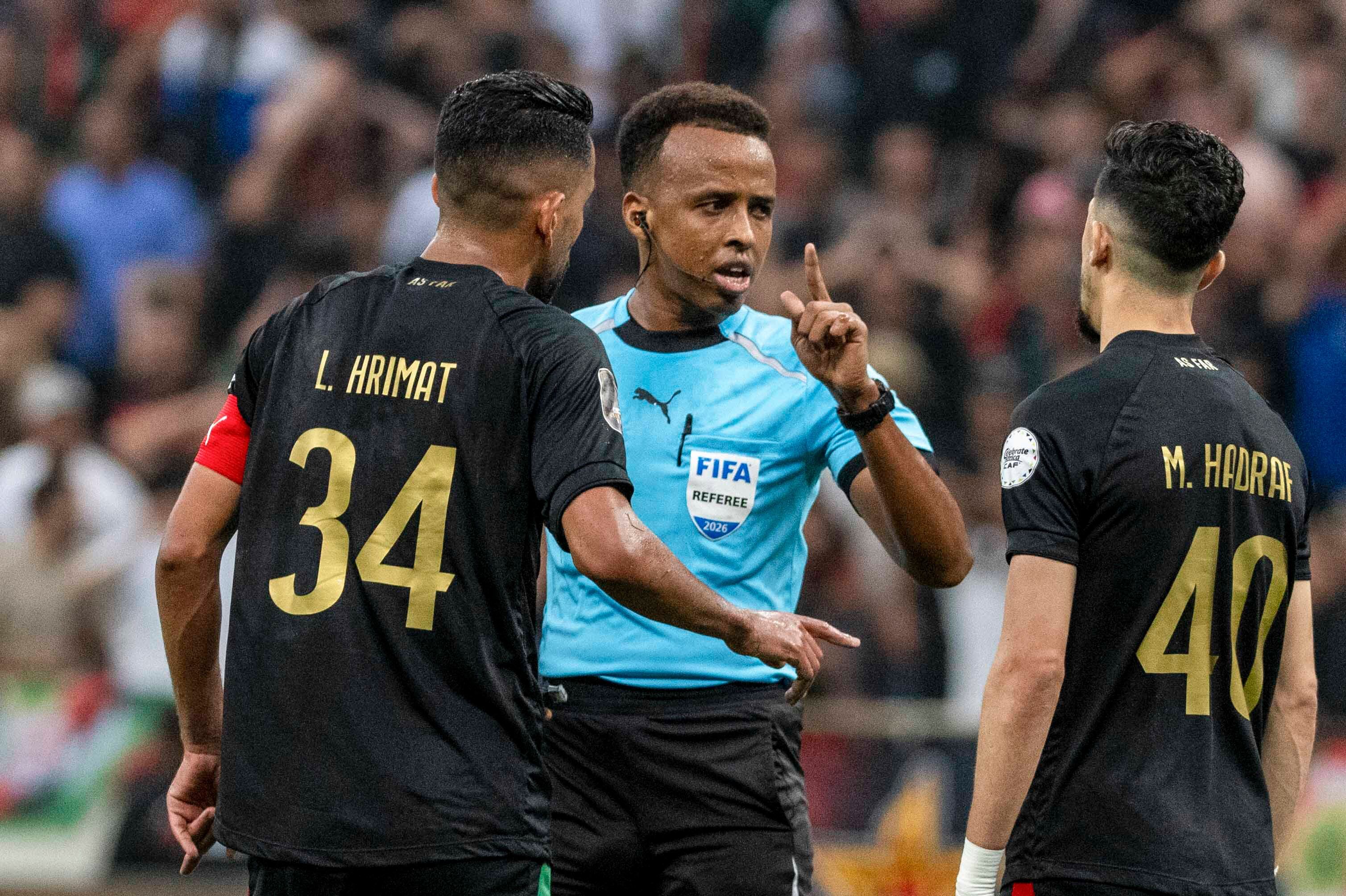 Referee Omar Artan of Somalia is confronted by players during the CAF Champions League final in Rabat, Morocco, May 24. Artan was denied entry into the U.S. on Tuesday, two days before the start of the World Cup.