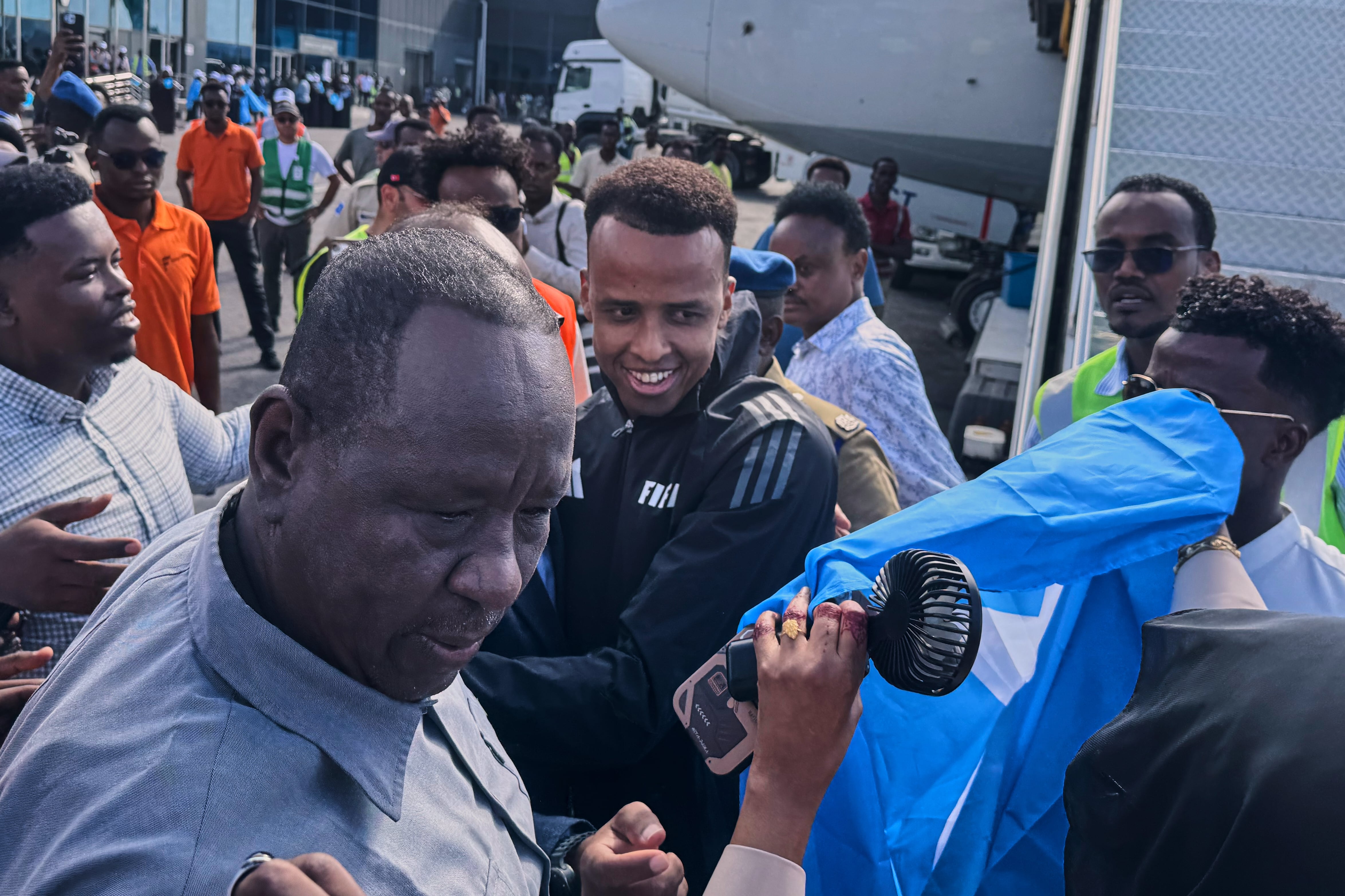 Referee Omar Artan, who was denied entry to the United States, is welcomed by supporters upon his arrival in Mogadishu, Somalia, Wednesday. The International Olympic Committee expressed confidence on Thursday that the same issues plaguing internationals heading to the FIFA World Cup would not happen at the 2028 Summer Olympics.