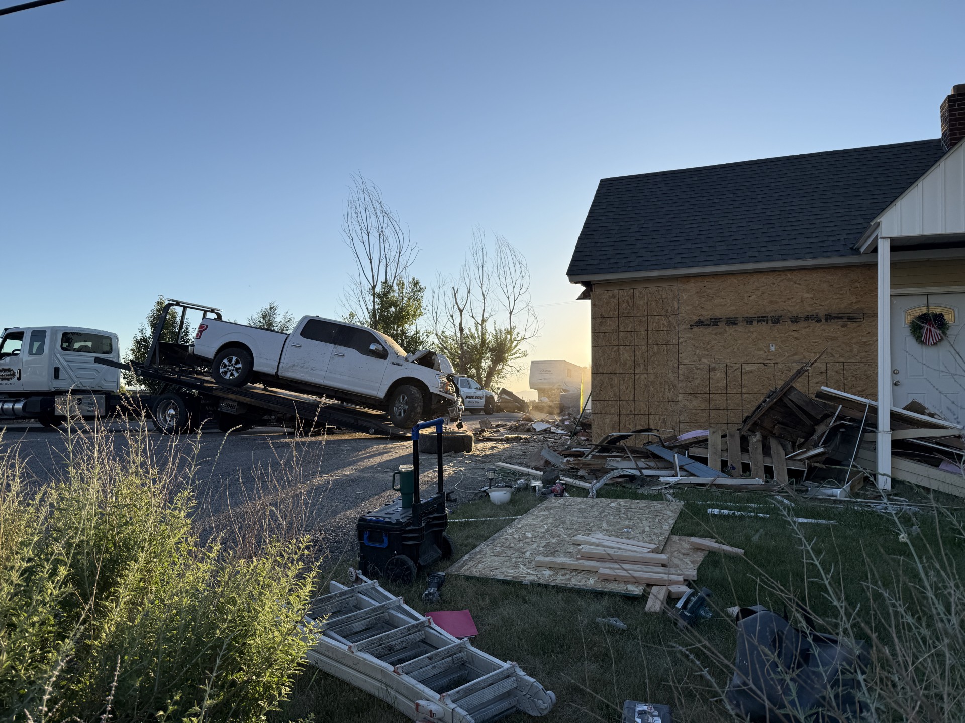 A truck is towed away after it crashed into a Perry home on Thursday,