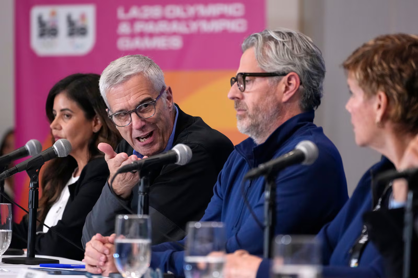 Reynold Hoover, LA28 Chief Executive Officer, speaks as Jacie Prieto Lopez, Vice President Communications at the LA28 Olympic & Paralympic Games, Casey Wasserman, LA28 Chairperson and President and Nicole Hoevertsz, Chair, IOC Coordination Commission for LA28, during a news conference June 4, in Los Angeles. Officials are confident immigration issues won't plague the Games.