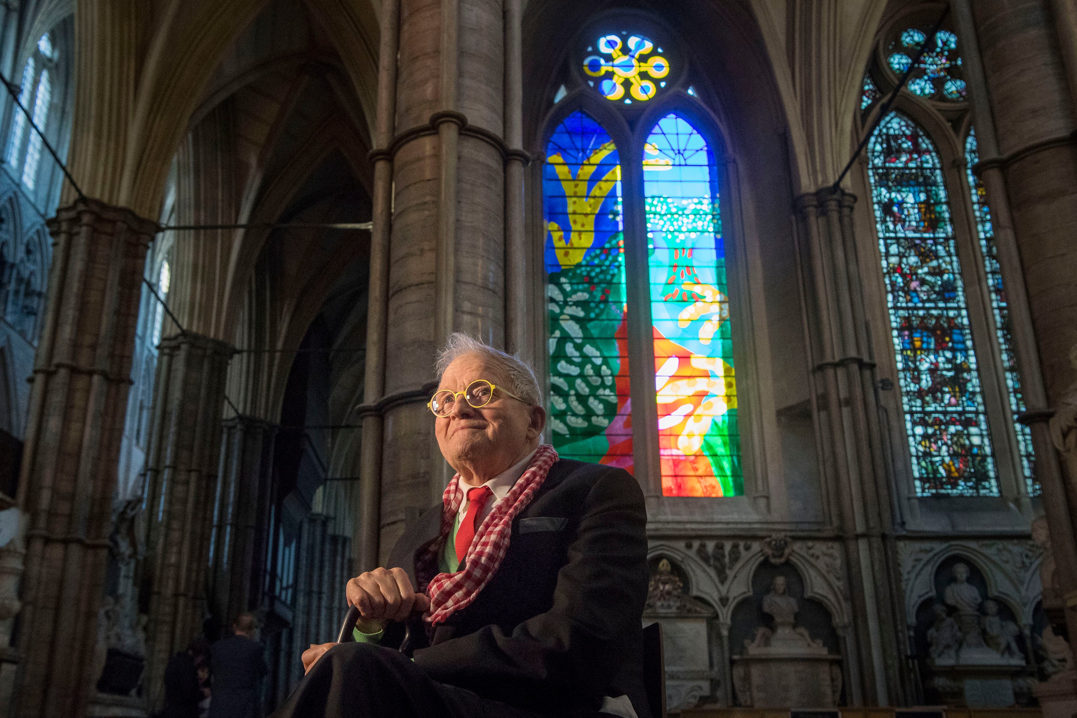 British artist David Hockney sits in front of The Queen's Window, a new stained-glass window at Westminster Abbey in London, designed by Hockney and unveiled for the first time on Sept. 26, 2018. Hockney died on Thursday at the age of 88, his publicist said Friday.