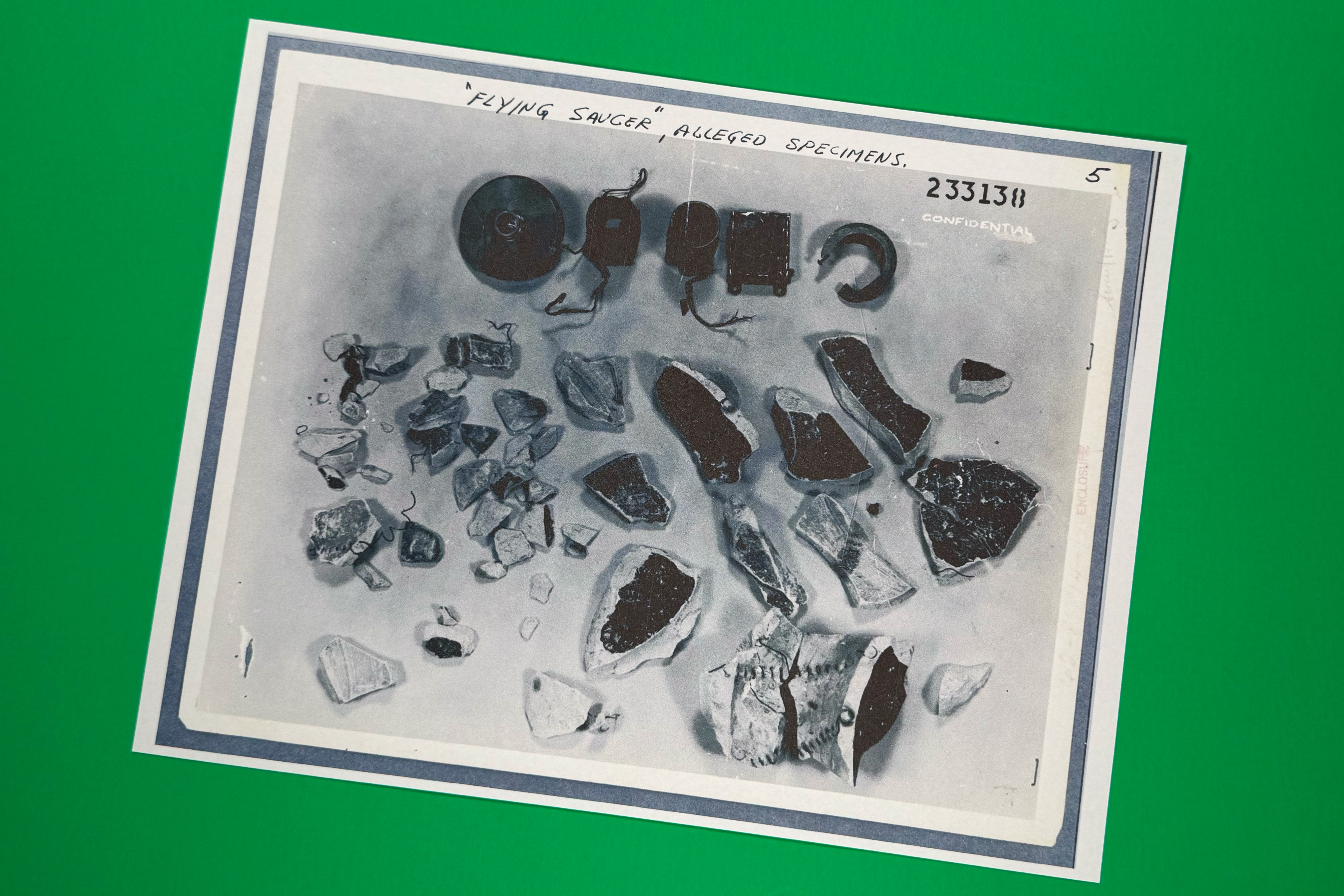 A photo of "flying saucer alleged specimens" in files on UFOs, released May 8 by the Pentagon, is photographed in Washington. The Pentagon released a third tranche of 72 files on Friday.