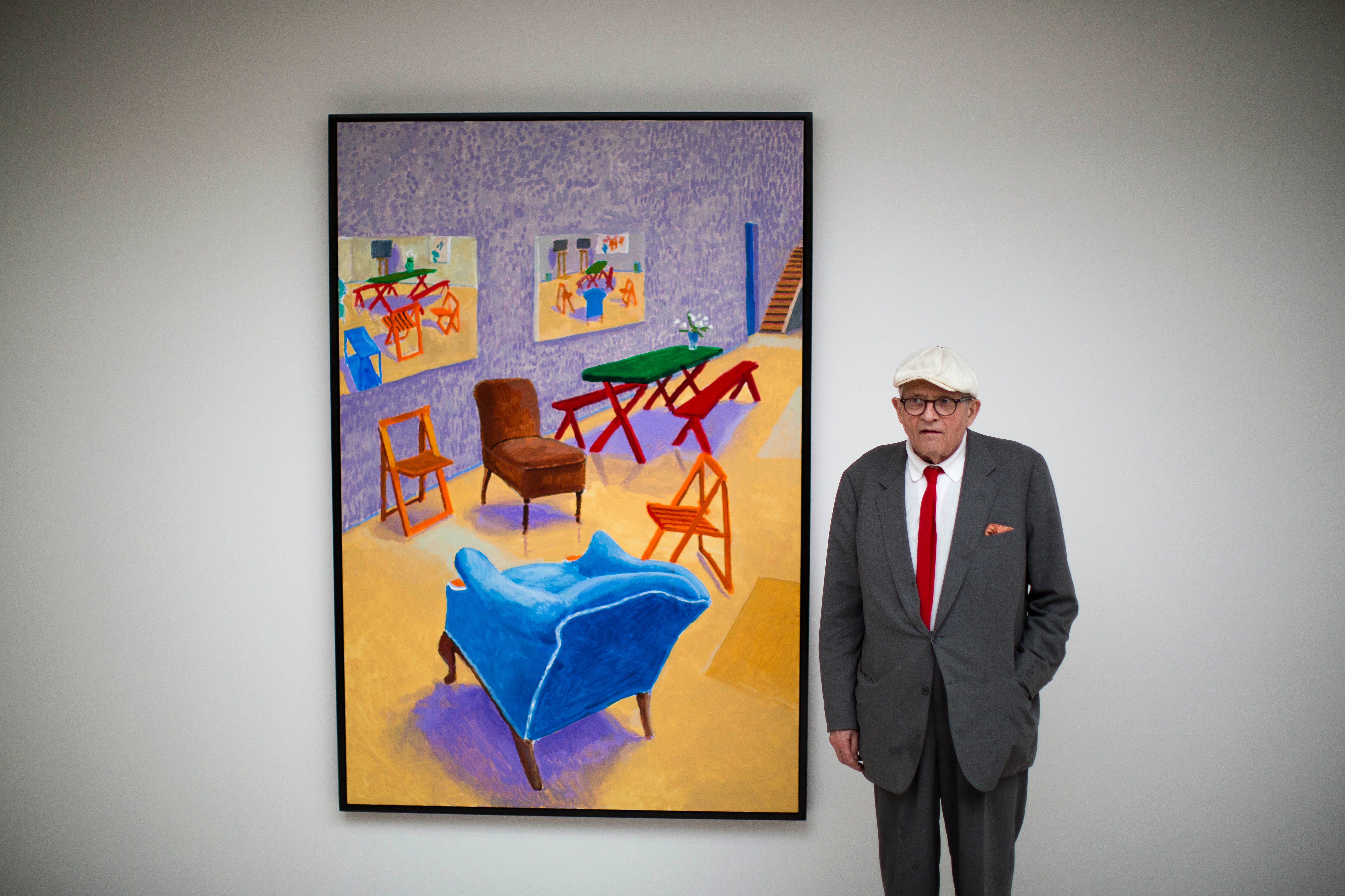 British artist David Hockney in front of his acrylic on canvas "Studio Interior #4" which features as part of the "David Hockney Painting and Photography" exhibition at the Annely Juda Fine Art gallery in London, May 14, 2015. Hockney died on Thursday at the age of 88, his publicist said on Friday.