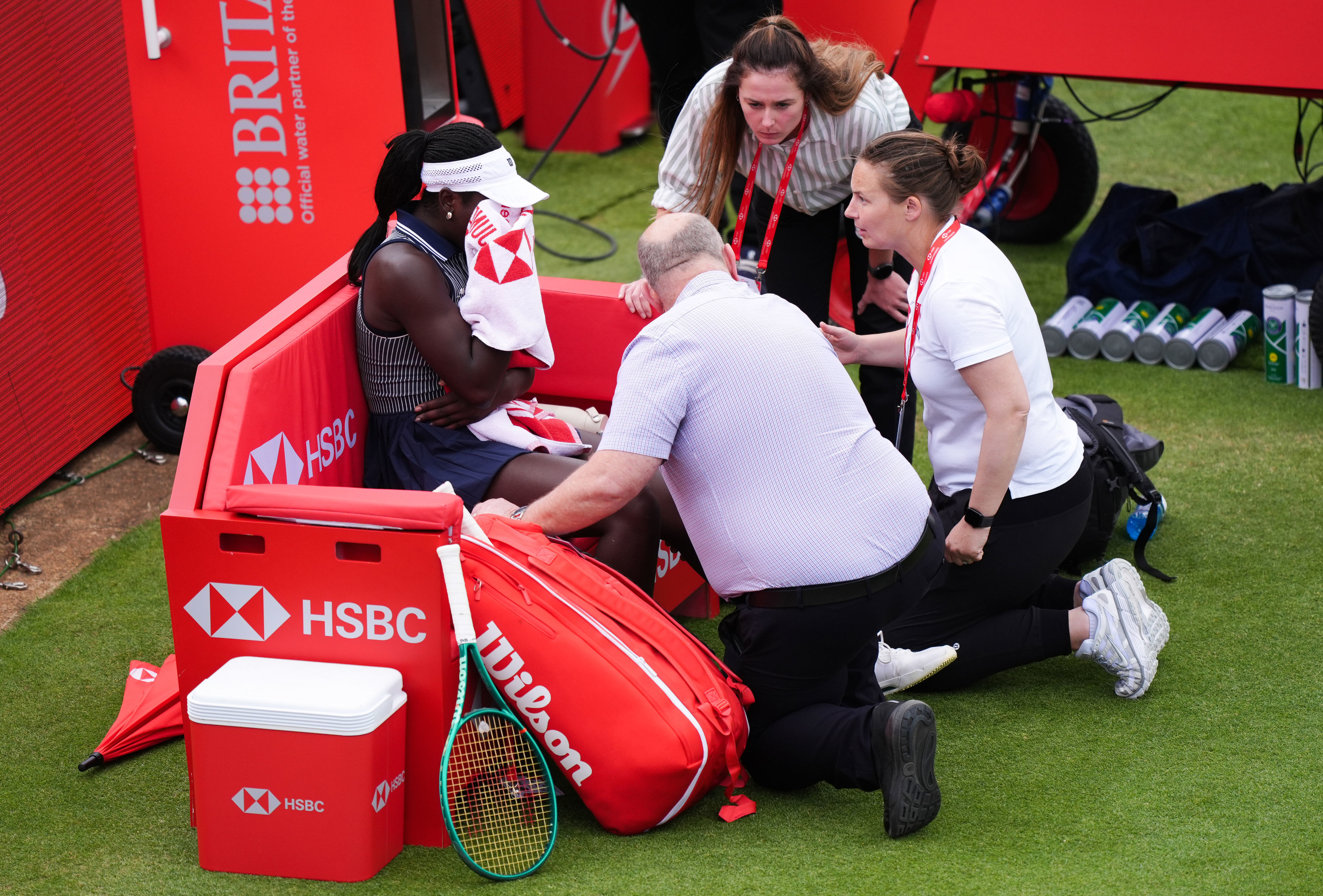 Victoria Mboko, left, of Canada retires injured during her match against Karolina Pliskova of Czech Republic on day three of the Queen's Club tennis championships in London, Wednesday, June 10, 2026.