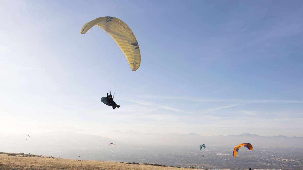 Paragliders fly at the Salt Lake County Flight Park in Draper on Jan. 16. A paraglider was taken to the hospital in serious condition after an accident in Salt Lake City on Friday.