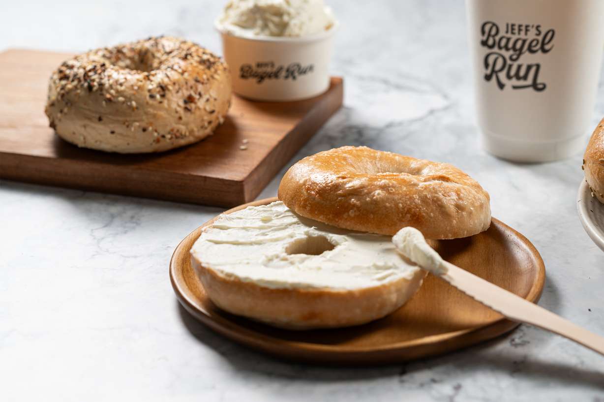 A bagel and spread from Jeff's Bagel Run is pictured. Utah's food scene is set to welcome two new players in Chicken Salad Chick and Jeff's Bagel Run, with each opening stores around the state.
