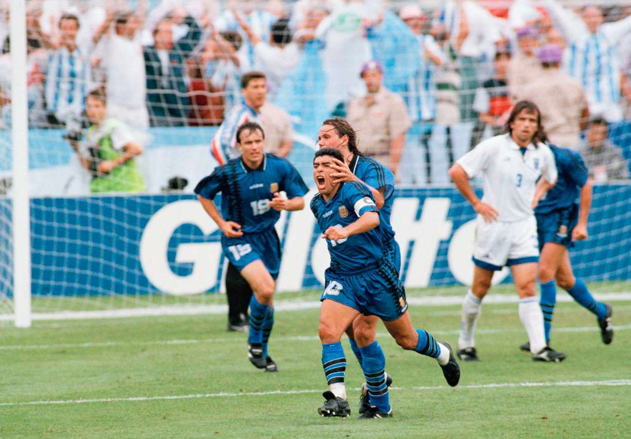 Argentina's Diego Maradona (10) is hugged by teammate Fernando Redondo after scoring a goal against Greece during a first round Group D World Cup soccer match, Tuesday, June 21, 1994, in Foxborough, Mass.