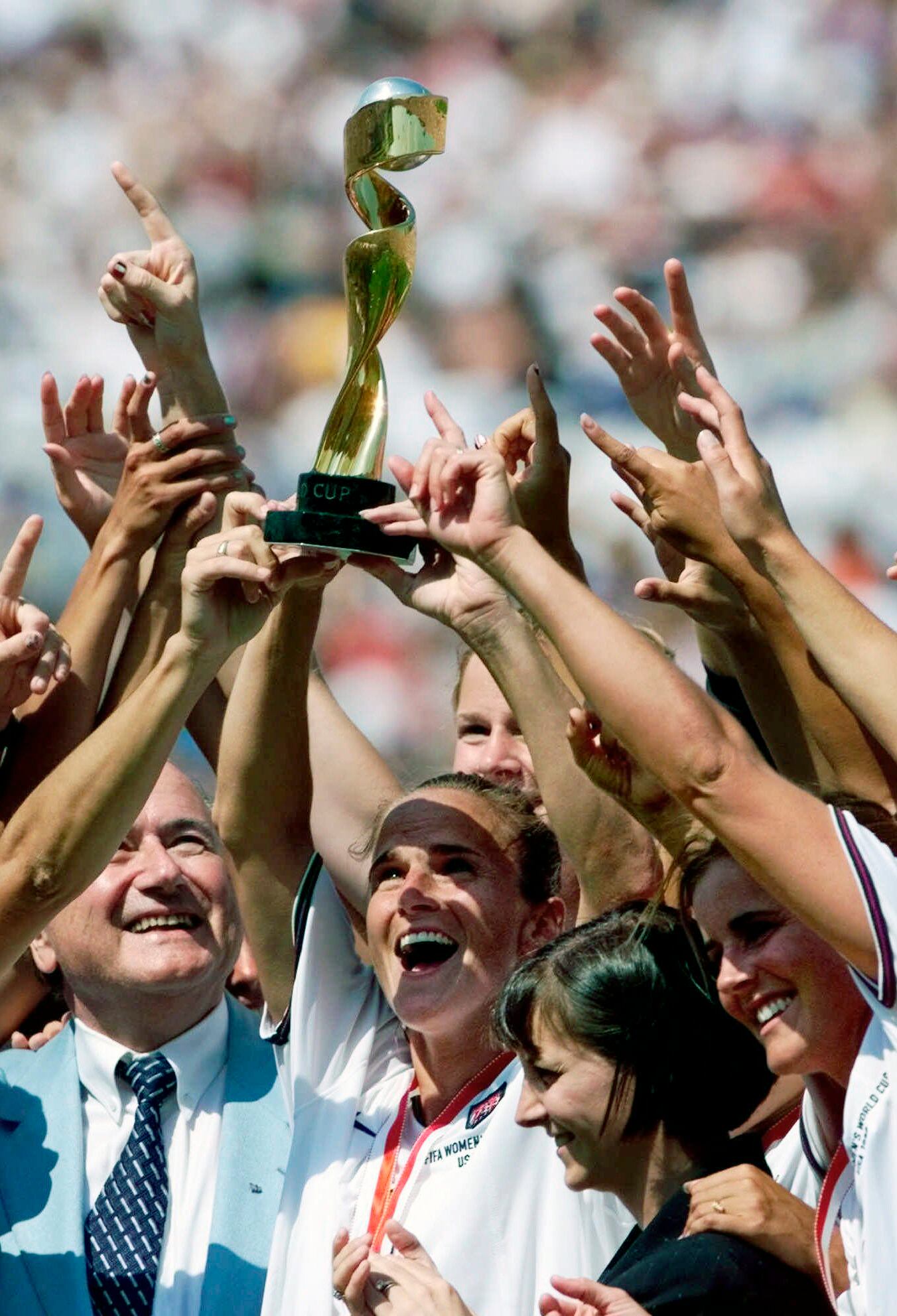 On July 10, 1999, U.S. women's soccer team captain Carla Overbeck, center, and other members of the U.S. team celebrate with the trophy after defeating China 5-4 in an overtime penalty shootout in the Women's World Cup final at the Rose Bowl in Pasadena, Calif.