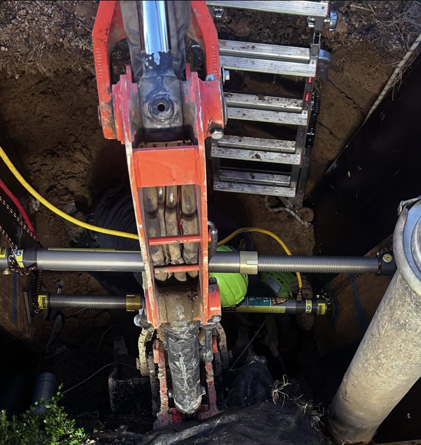 Crews rescue a man who became trapped in a trench while working at a construction site in Mapleton on Thursday.