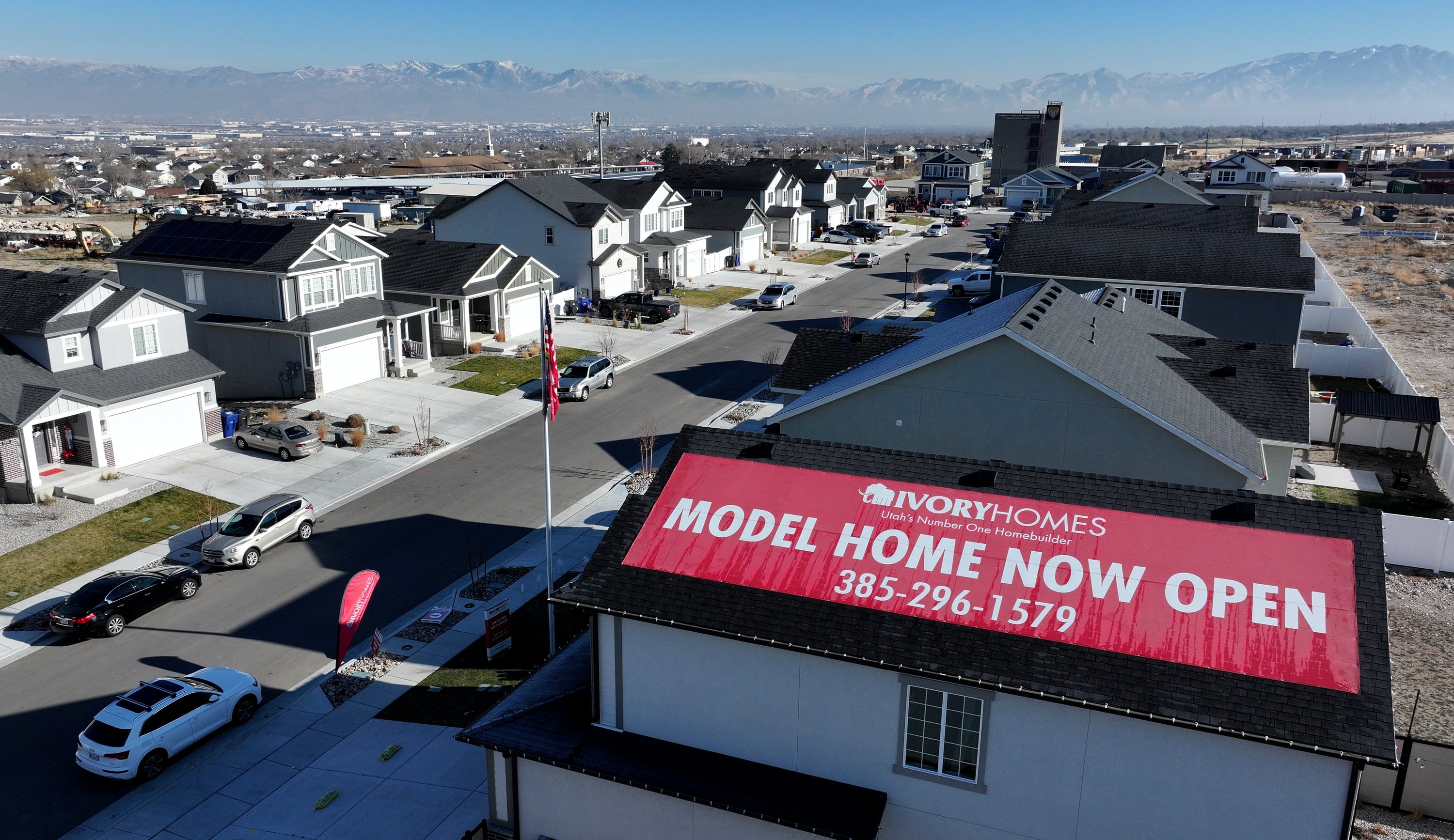 A model home sign is pictured on a Mahogany Ridge home in Magna on Dec. 30. Despite the rise in median home prices, Chen Zhao of Redfin said the door is still open for buyers to negotiate their own prices.