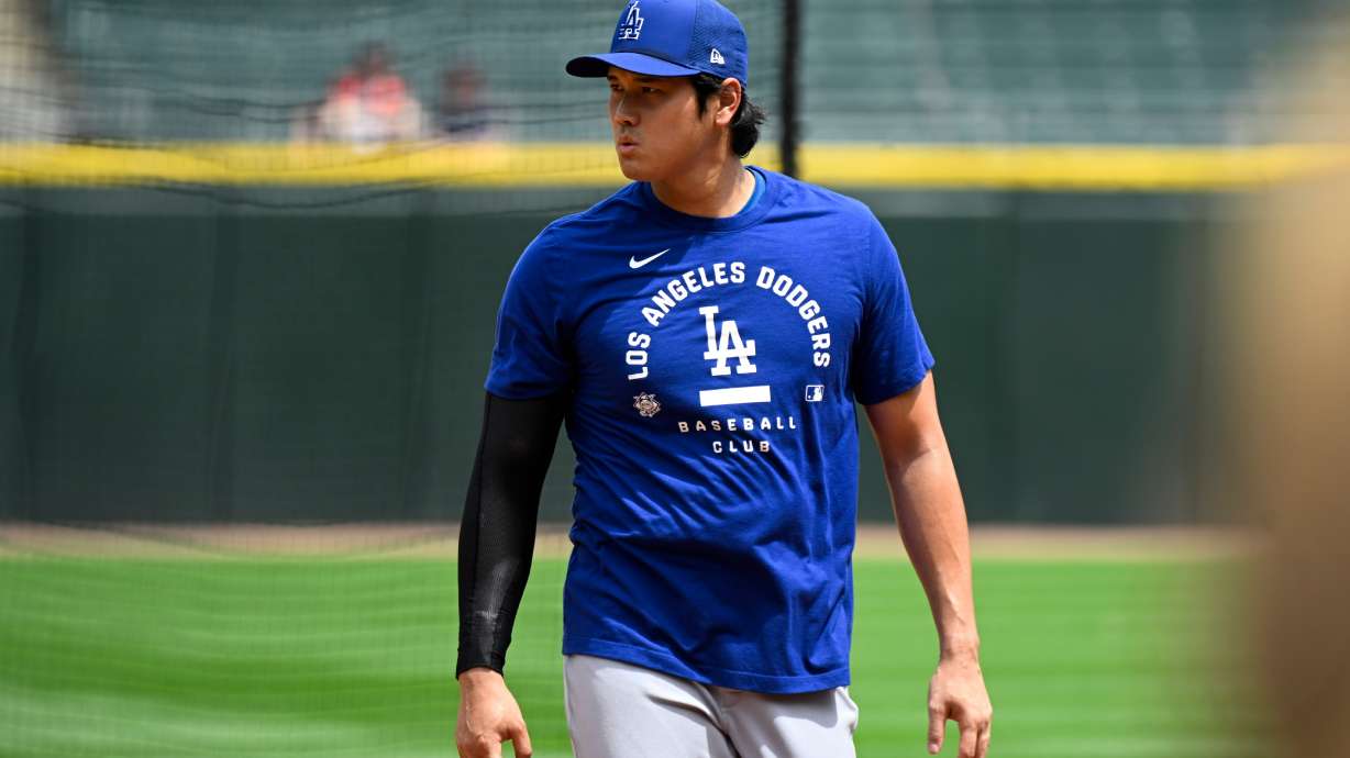 Los Angeles Dodgers two-way player Shohei Ohtani, from Japan, during warmups before a baseball game against the Chicago White Sox, Saturday, June 13, 2026, in Chicago.