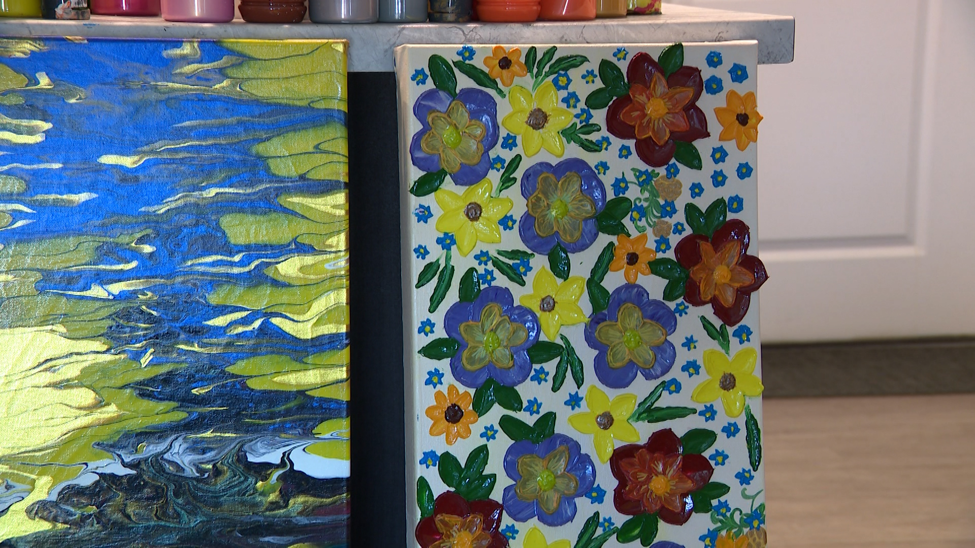 Paintings by Olha Svieshnikova are pictured in her Sandy apartment on Friday. Svieshnikova, a refugee from Ukraine, said art is her life and her soul.