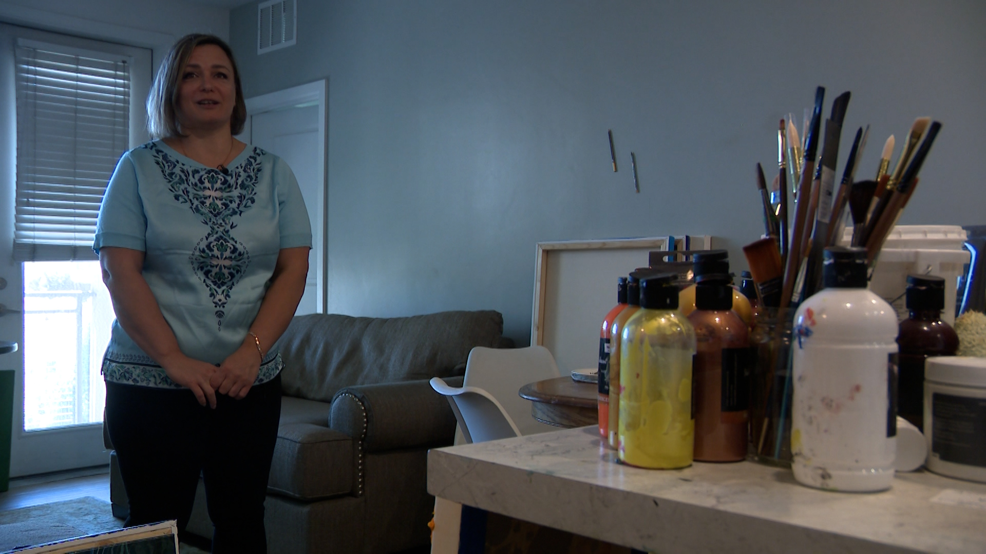 Olha Svieshnikova stands in her Sandy apartment near her art supplies on Friday. Svieshnikova is currently competing in an art competition.