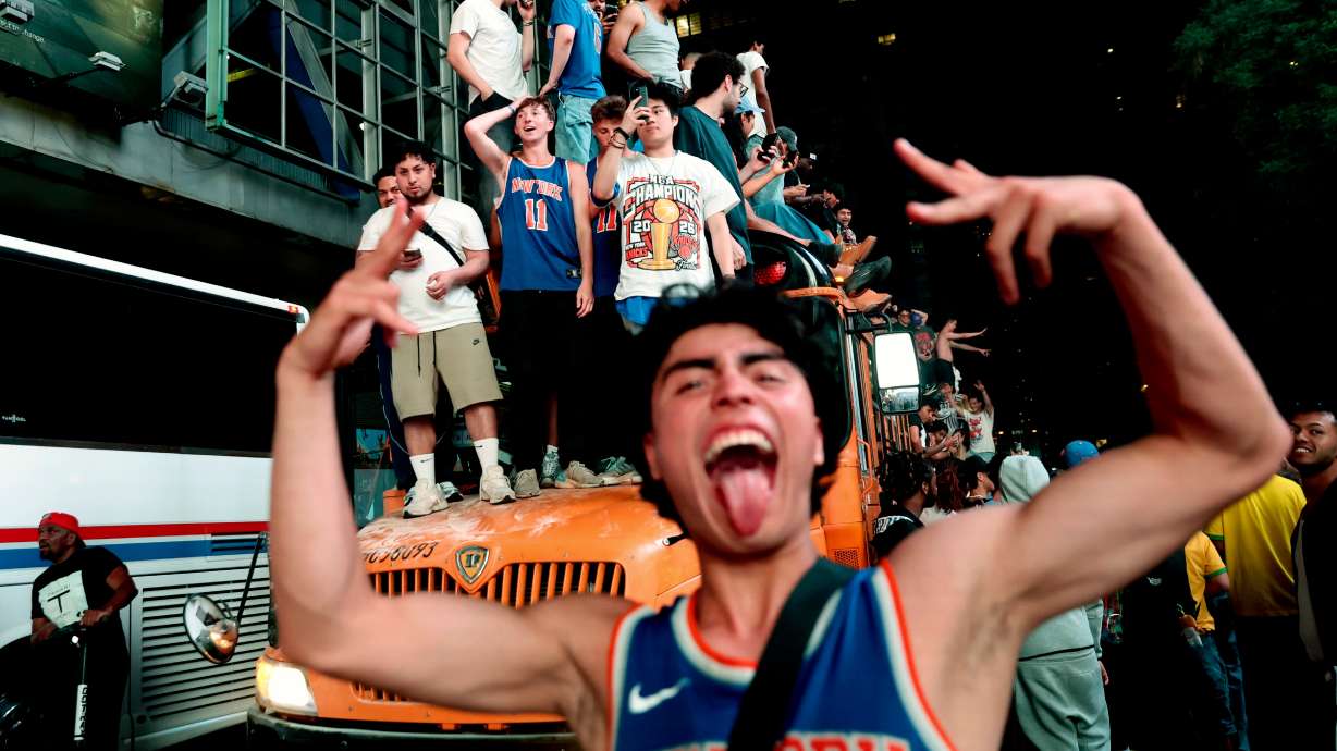 New York Knicks fans celebrate their victory after Game 5 of the NBA Finals basketball series against the San Antonio Spurs, Saturday, in New York.
