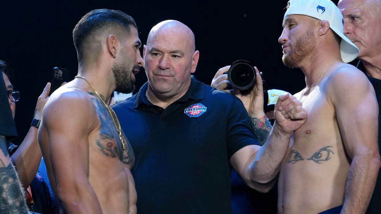 UFC commentator Joe Rogan, center, with Ilia Topuria, left, and Justin Gaethje, right, during the ceremonial UFC Freedom 250 weigh-ins on the Ellipse, Saturday, June 13, 2026, in Washington, ahead of Sunday's fight on the South Lawn of the White House.