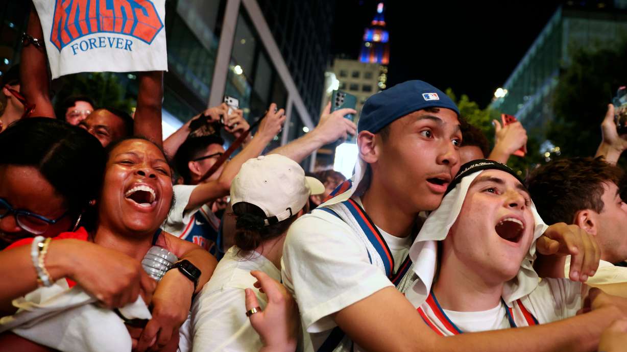 New York Knicks fans celebrate after winning Game 5 of the NBA Finals basketball series against the San Antonio Spurs, Saturday, June 13, 2026, in New York.