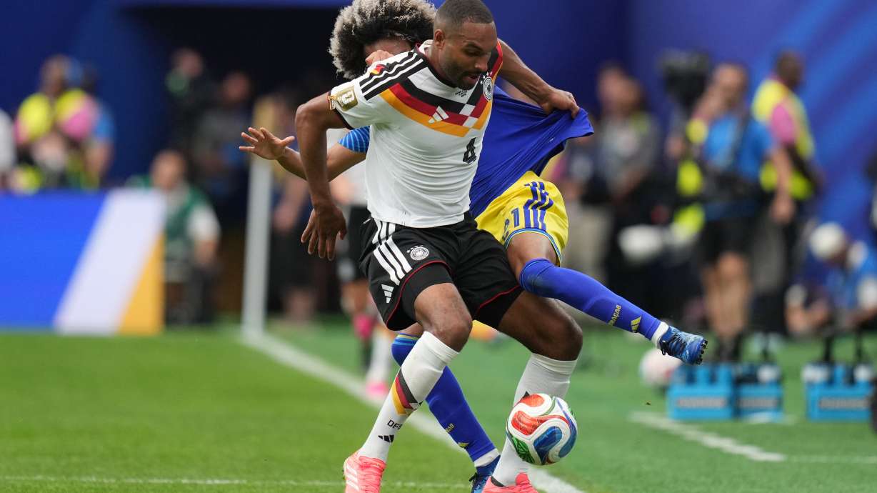 Germany's Jonathan Tah, front , and Curaçao's Tahith Chong fight for the ball during the World Cup Group E soccer match between Germany and Curacao in Houston, Sunday, June 14, 2026.