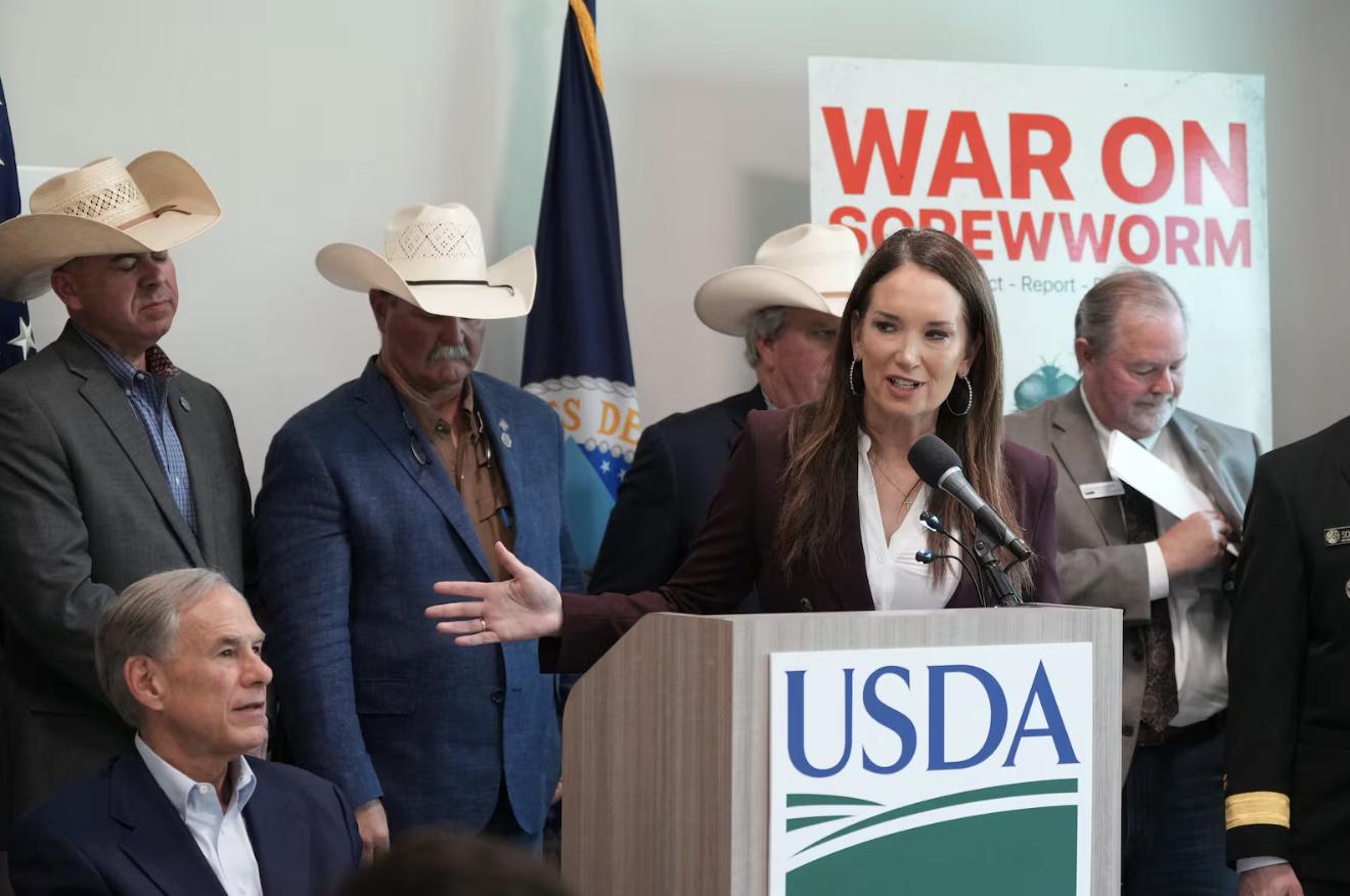 U.S. Agriculture Secretary Brooke Rollins, right, and Texas Gov. Greg Abbott, front left, hold a news conference with ranchers, researchers and officials at the Knipling-Bushland U.S. Livestock Insects Research Laboratory in Kerrville, Texas, Monday.