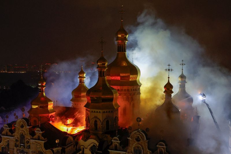 Firefighters work to extinguish a fire at the Dormition Cathedral of the Kyiv Pechersk Lavra, which was hit during Russian missile and drone strikes, amid Russia's attack on Ukraine, in Kyiv, Ukraine, Sunday.