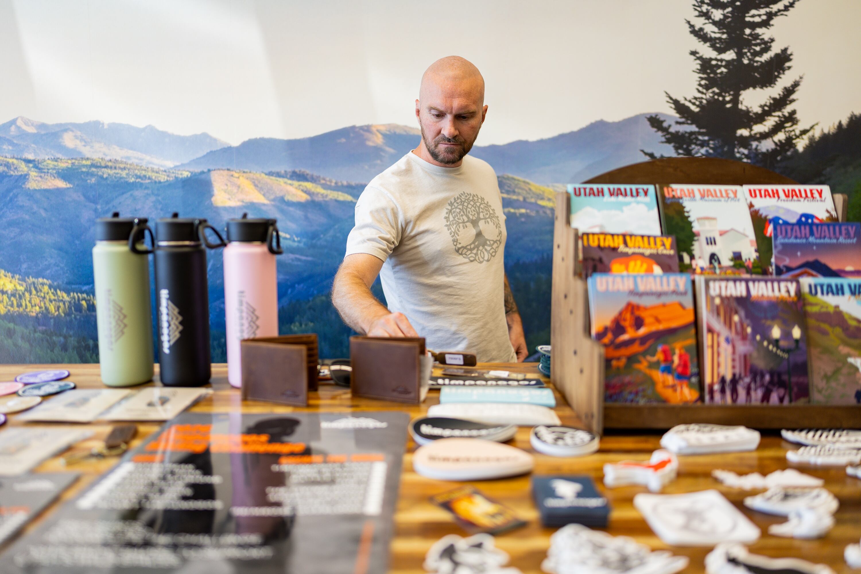 Joe Vogel, owner of Timpanogos Hiking Co., fixes merchandise at his store Timpanogos Hiking Co. in Provo on June 12.