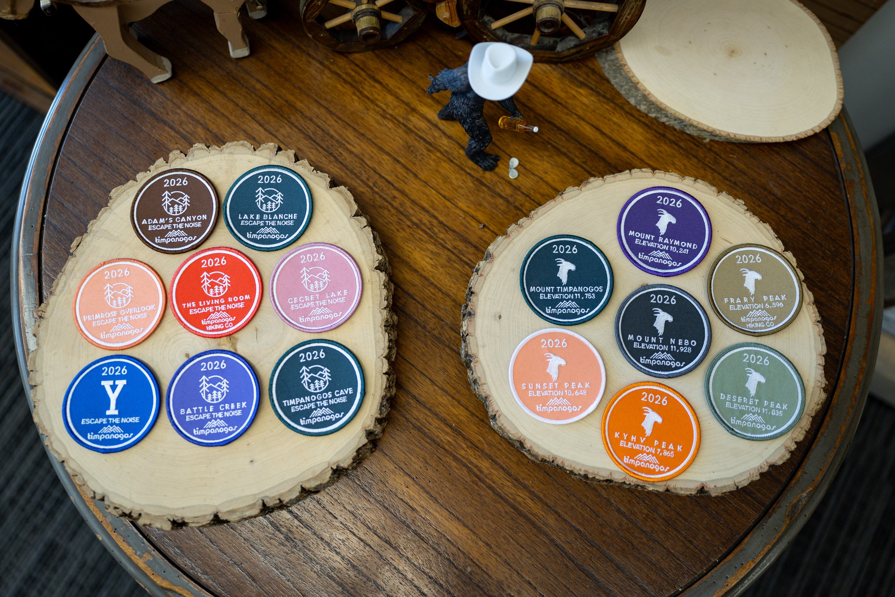 Badges for hikes on the 2026 Timpanogos Hiking Challenge in Timpanogos Hiking Co. in Provo on June 12.