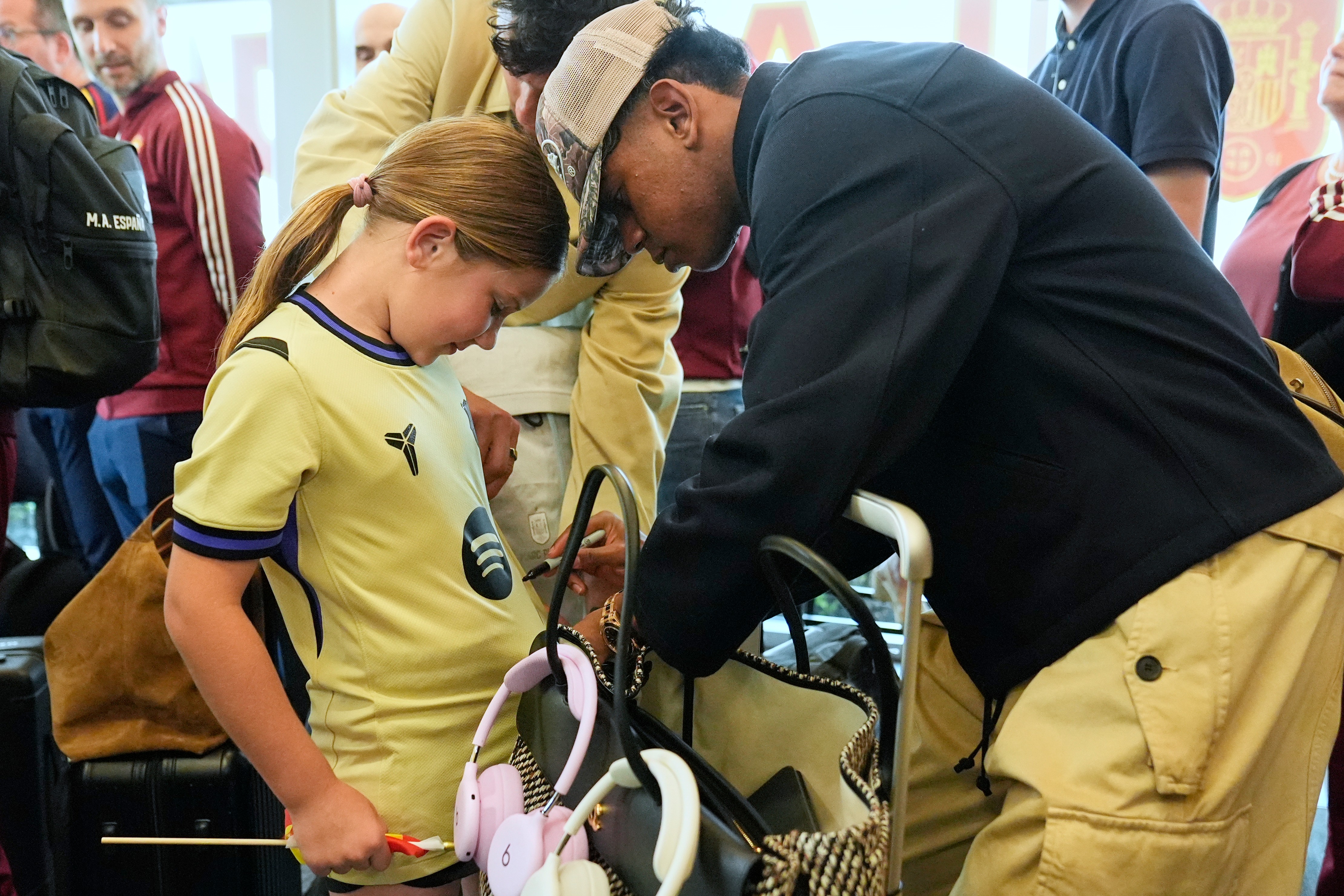 Spain midfielder Lamine Yamal, right, signs an autograph for Griffin Wamp, left, after arriving with teammates for the World Cup soccer tournament Friday, June 5, 2026, in Chattanooga, Tenn.
