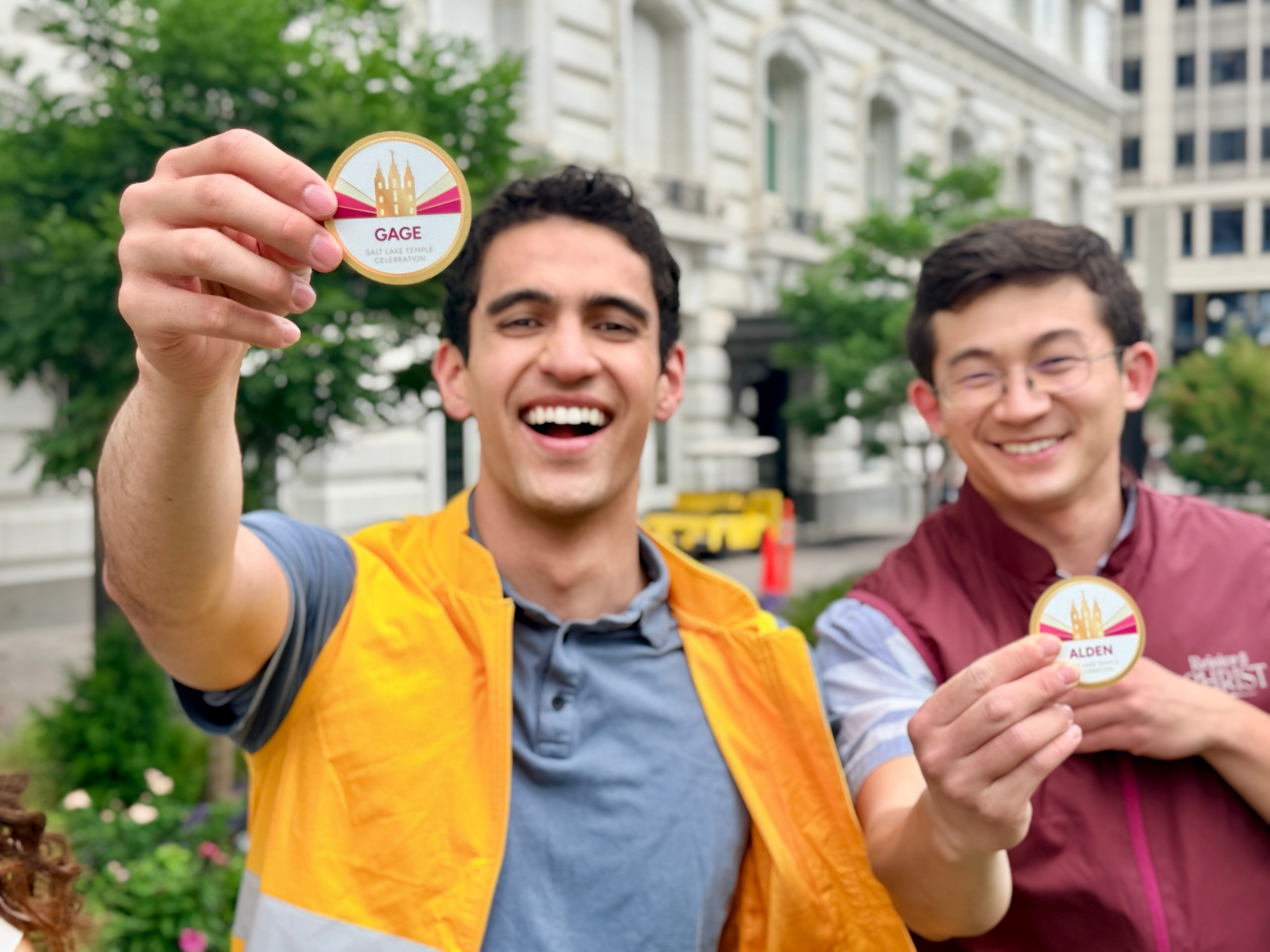Volunteers display their name tags for Salt Lake Temple Celebration events. Volunteer applications are now open.