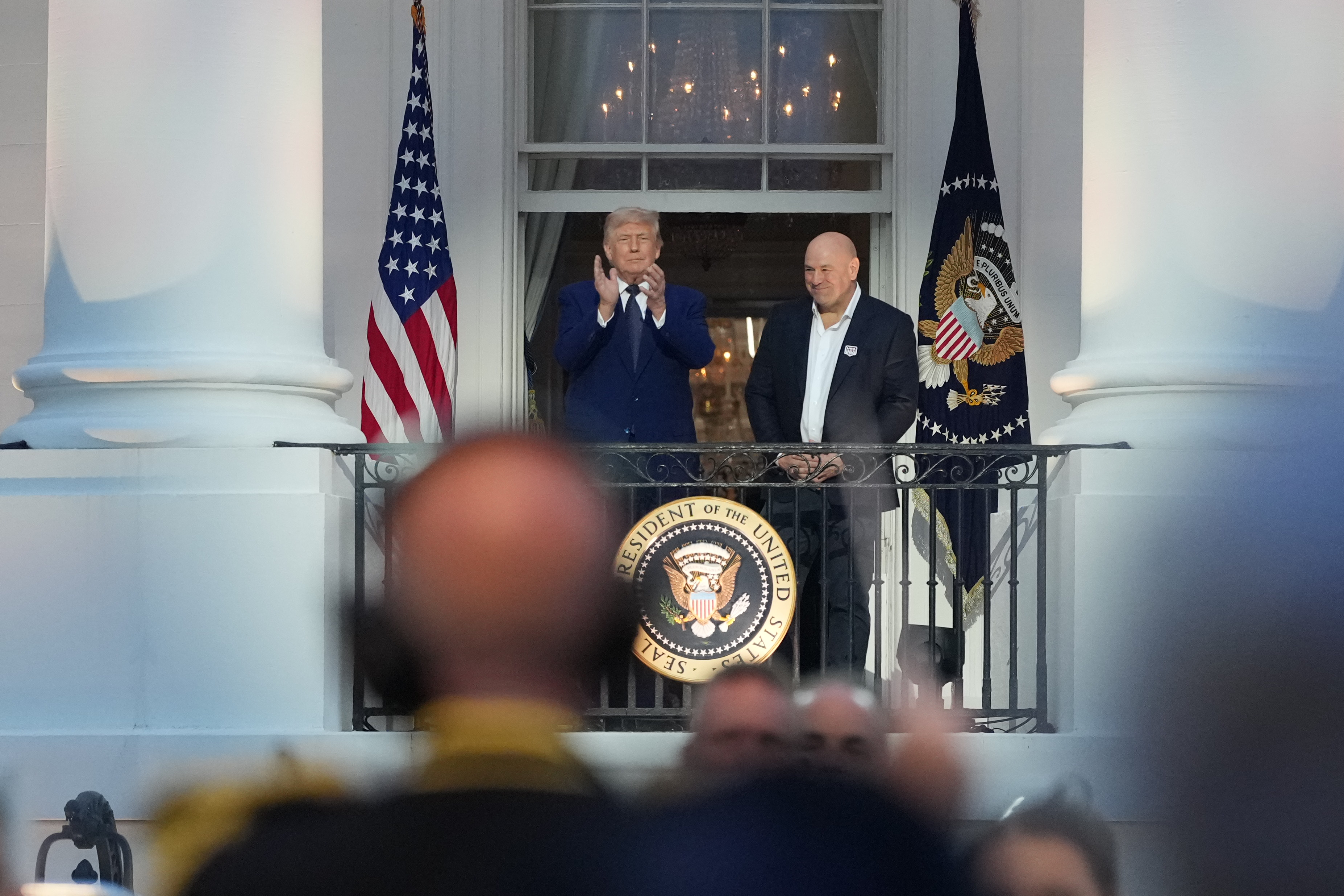President Donald Trump and Dana White, UFC president and CEO, arrive on the Blue Room Balcony for the National Anthem before UFC Freedom 250 on the South Lawn of the White House, Sunday, June 14, 2026, in Washington. (AP Photo/Alex Brandon)