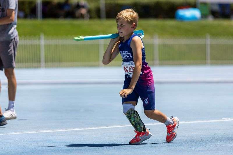 Zach Adler, 10, throws the javelin at a recent track meet. Zach was born without a fibula in his right leg, requiring amputation below his knee.