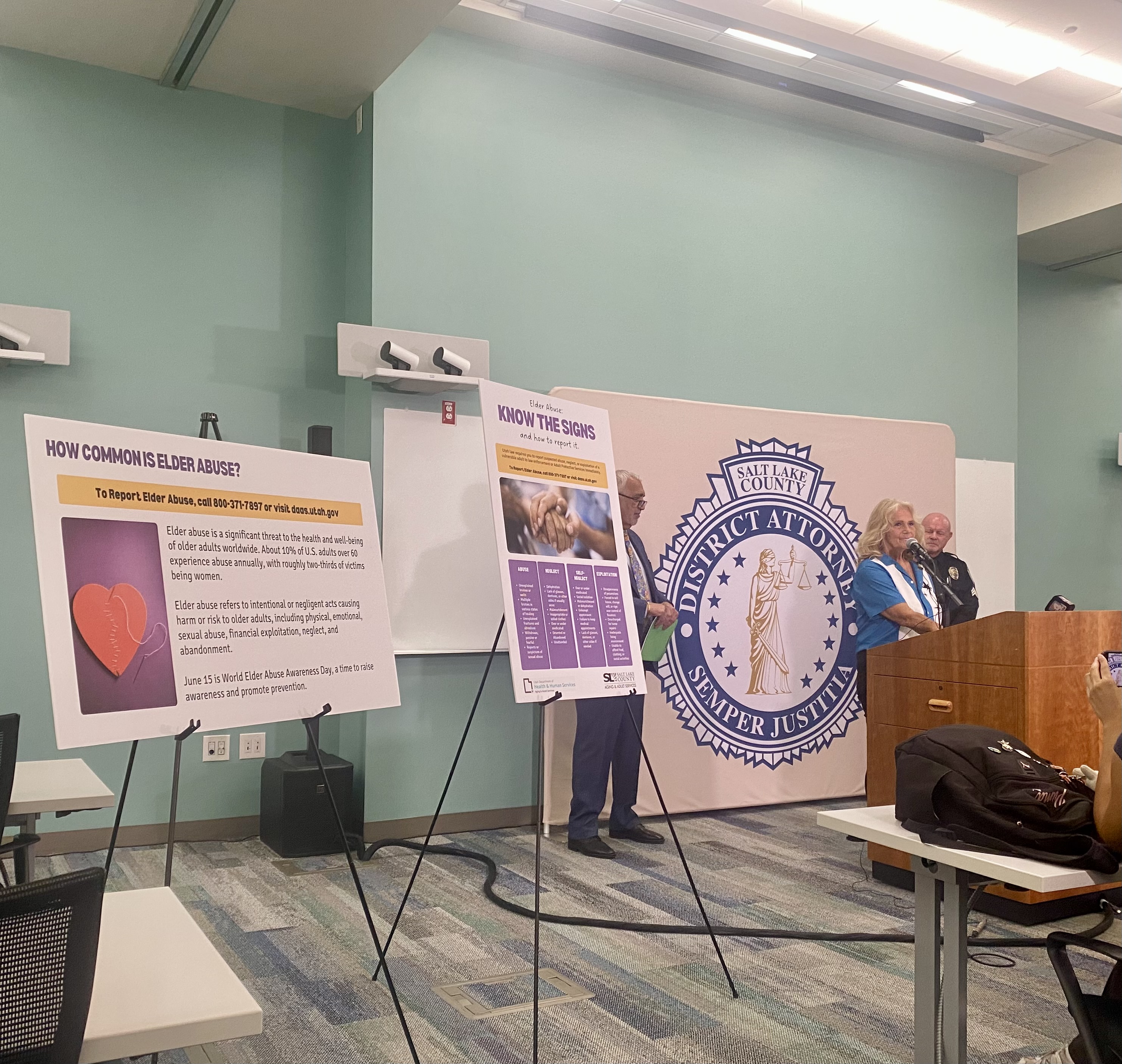 Salt Lake County District Attorney Sim Gill is joined by Debbie Hall, director at Adult Daycare at Neighborhood House, and Sandy Police Sgt. Ron Anson to mark World Elder Abuse Awareness Day.