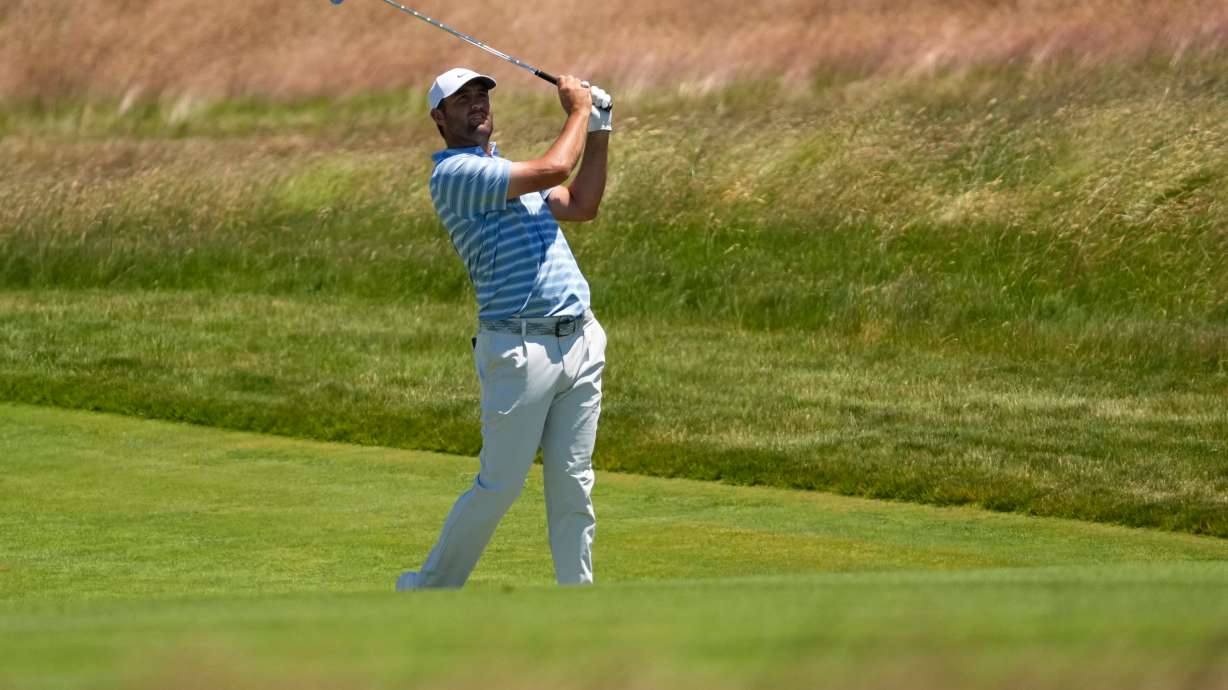 Scottie Scheffler watches his shot on the 13th hole during a practice round for the U.S. Open golf tournament at Shinnecock Hills Golf Club in Southampton, N.Y., Monday, June 15, 2026.