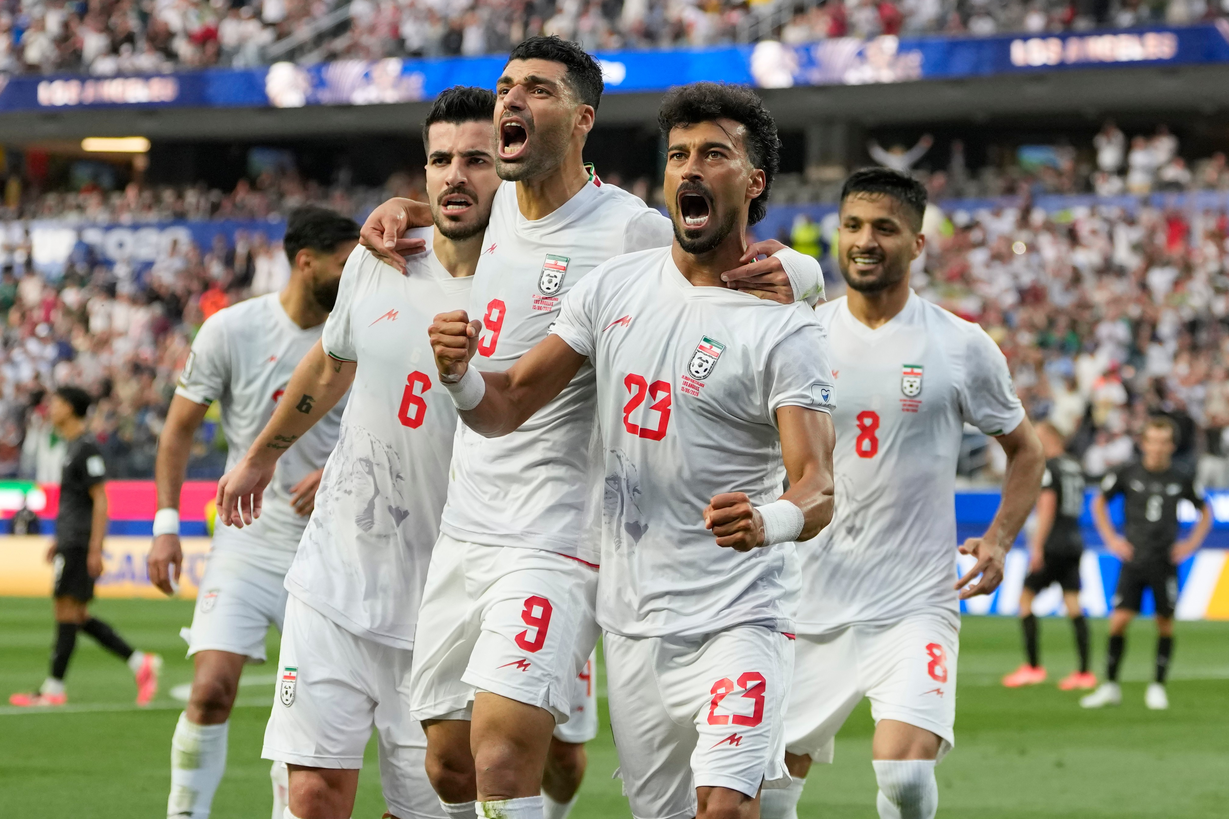 Iran opens its politically charged World Cup by playing to a 2-2 draw with New Zealand