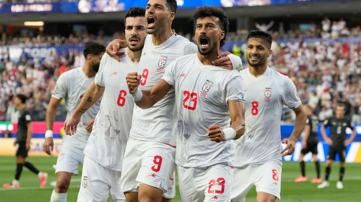 Iran's Ramin Rezaeian (23) celebrates with his teammates after scoring a goal during the World Cup Group G soccer match between Iran and New Zealand in Inglewood, Calif., near Los Angeles, Monday, June 15, 2026.
