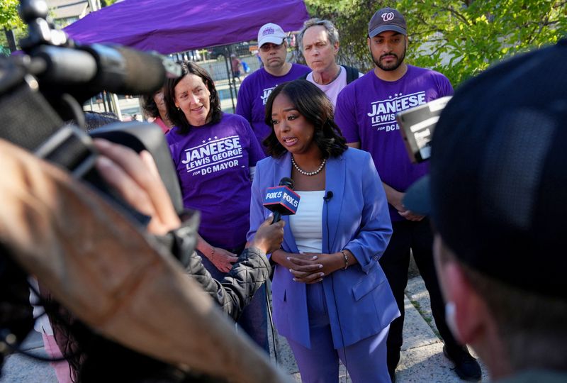 DC mayoral candidate Janeese Lewis George gives an interview with members of the news media next to a voting site at the Chevy Chase Community Center during primary voting day in Washington, Tuesday. George appeared to be the frontrunner in the Democratic mayoral primary, but no winner was called.