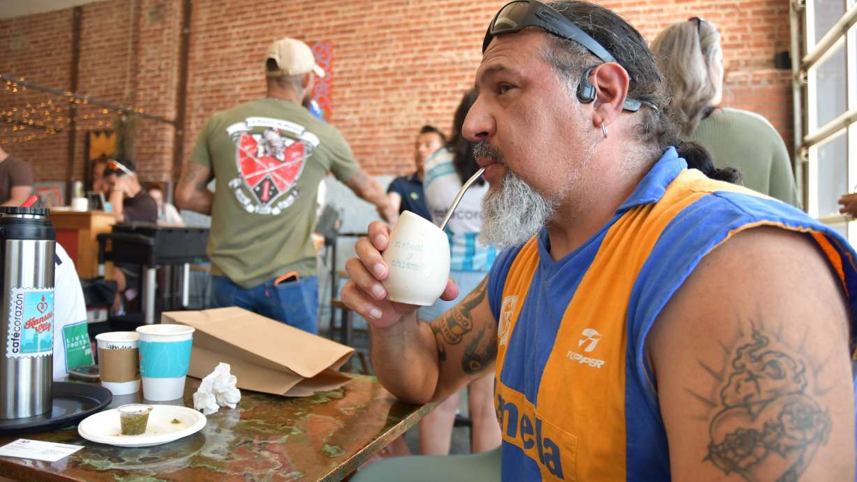 Rene Cufre, of Albuquerque, N.M., sips yerba mate at Cafe Corazon, Monday, June 15, 2026, in Kansas City, Mo.