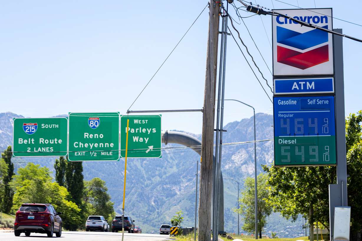 Cars drive past a Chevron on Foothill Drive in Salt Lake City on Monday. Experts warn a steep drop in gas prices will take time, despite the U.S. and Iran signing a deal to end the war in the Middle East.